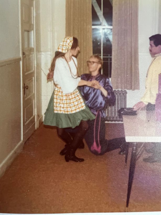 Me dressed in Russian costume, the end of one of the dances, where I twirl the girl in, kneel, and she sits on my knee. Partner unknown.